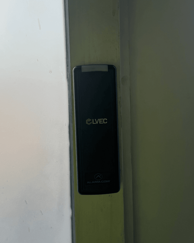 LVEC badge reader installed on a glass door frame