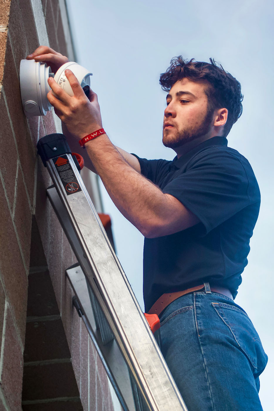 A LVEC technician working on a commercial security stytem.