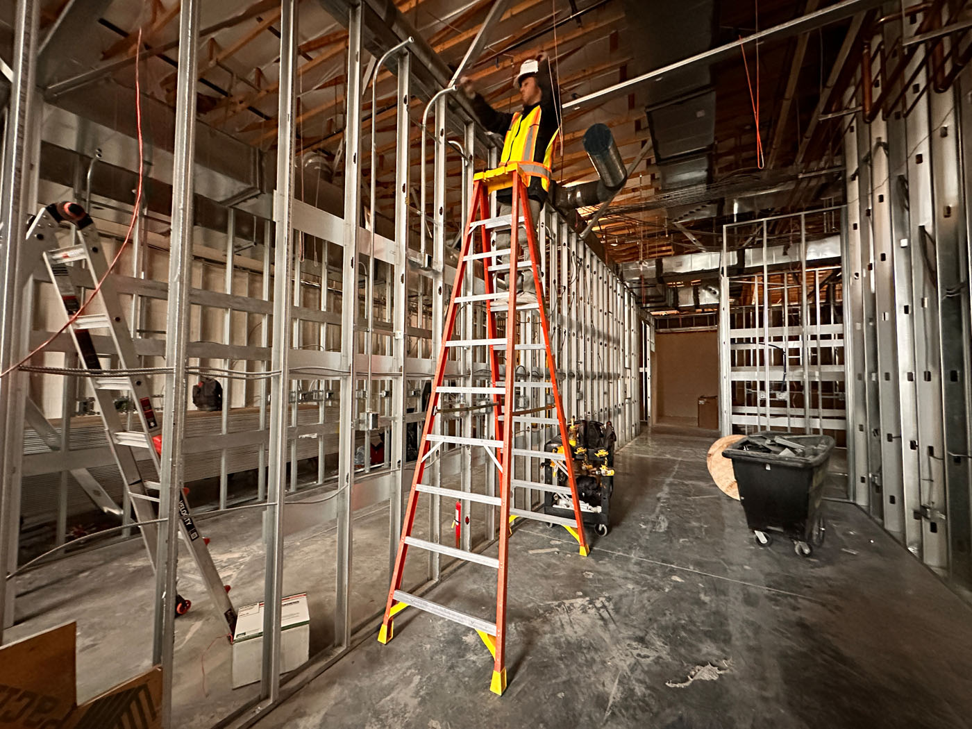 A low voltage contractor working on installing cameras at a construction site.