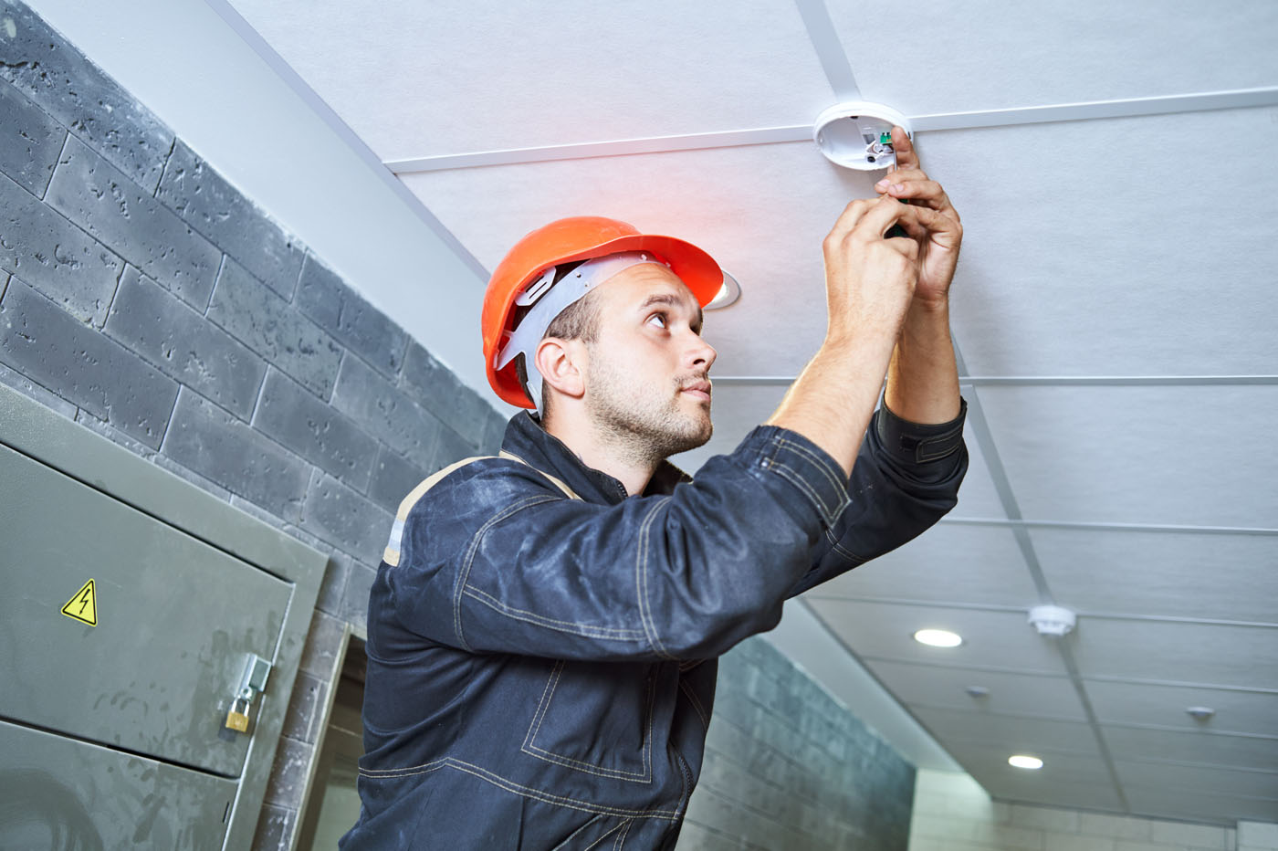 A LVEC technician installing a fire alarm from one of our trusted brand partners.